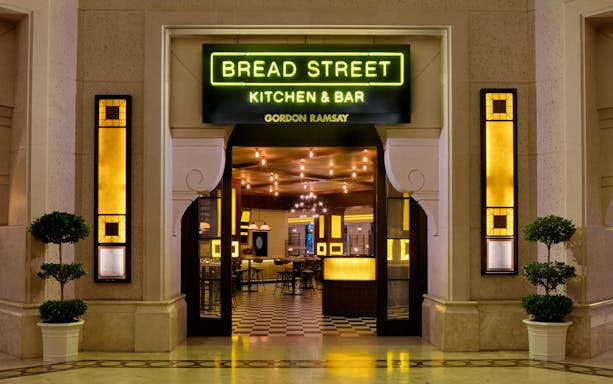 Entrance to Bread Street Kitchen by Gordon Ramsay in Dubai, featuring warm interior lighting.