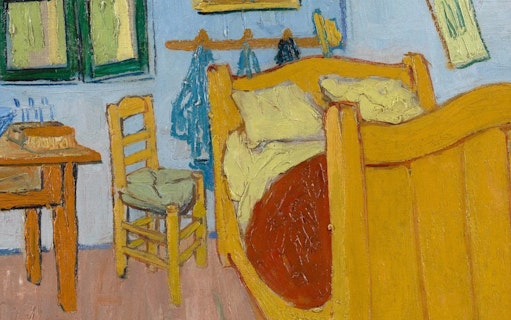 Van Gogh Museum Amsterdam bedroom exhibit with iconic yellow bed and chair.