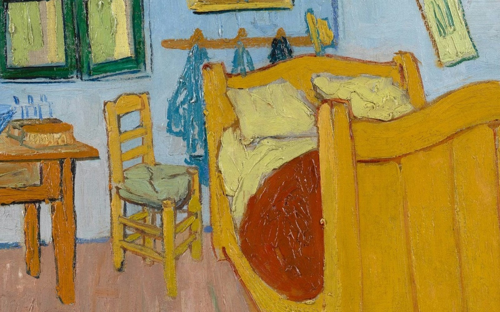 Van Gogh Museum Amsterdam bedroom exhibit with iconic yellow bed and chair.