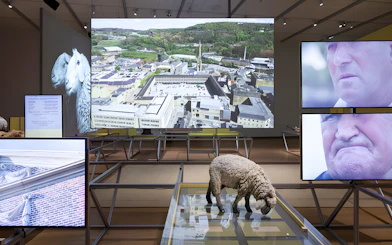 Formafantasma exhibit at Stedelijk Museum, Amsterdam, featuring Oltre Terra installation with multimedia displays.