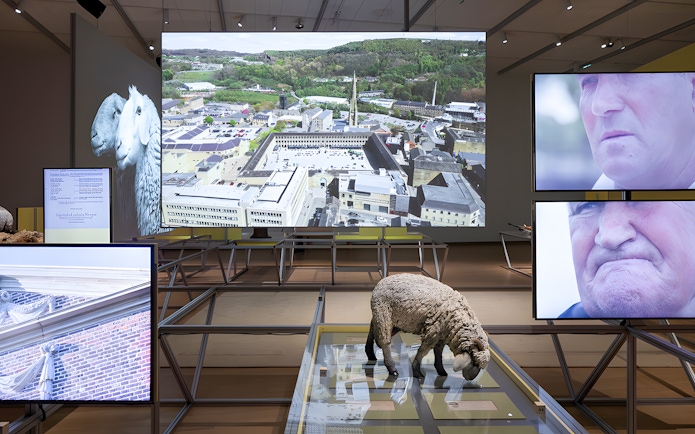 Formafantasma exhibit at Stedelijk Museum, Amsterdam, featuring Oltre Terra installation with multimedia displays.