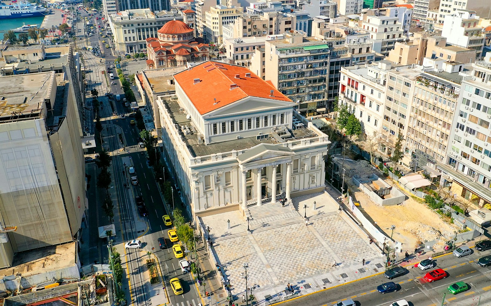 Piraeus Municipal Theatre with Athens hop on hop off bus in foreground.