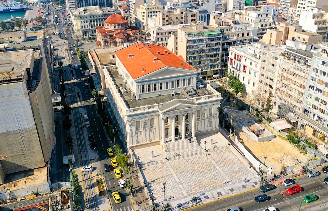 Piraeus Municipal Theatre with Athens hop on hop off bus in foreground.