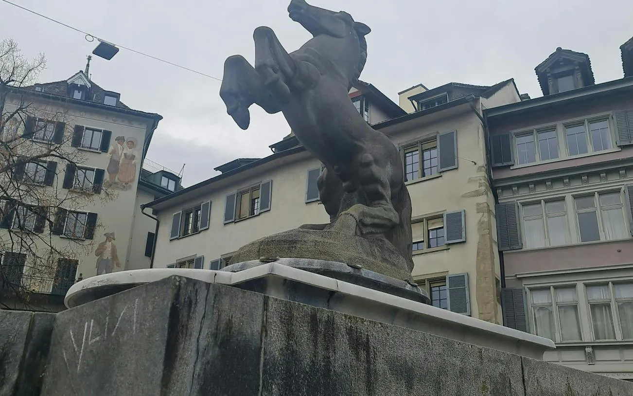 Rearing horse statue in Zurich's old town, part of the self-guided city exploration game.