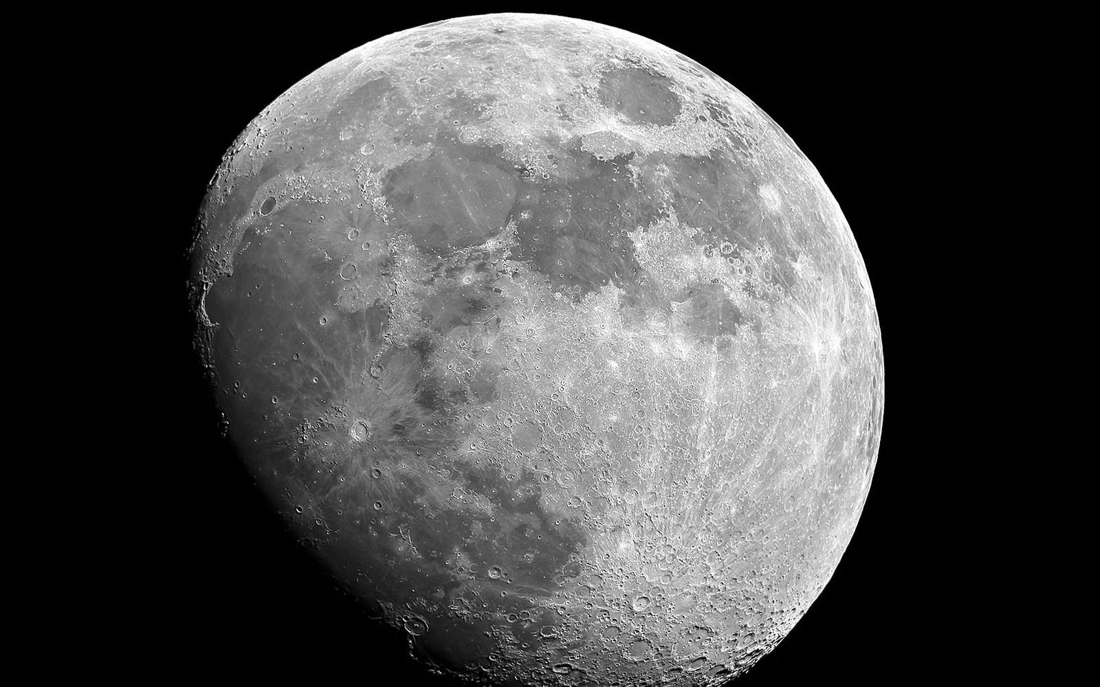 Moon in waxing gibbous phase with visible craters and surface details.