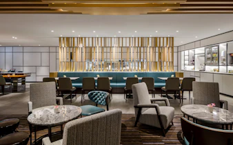 Plaza Premium Lounge seating area with tables and chairs, Zone C, Taipei, Taiwan.