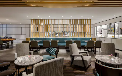 Plaza Premium Lounge seating area with tables and chairs, Zone C, Taipei, Taiwan.