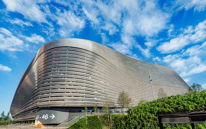 Santiago Bernabeu stadium exterior with modern architecture in Madrid.