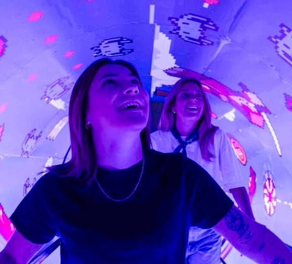 Visitors enjoying interactive digital art at Mind Games - Art Alive! exhibit.