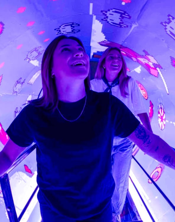 Visitors enjoying interactive digital art at Mind Games - Art Alive! exhibit.