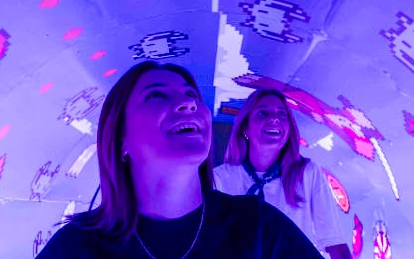 Visitors enjoying interactive digital art at Mind Games - Art Alive! exhibit.