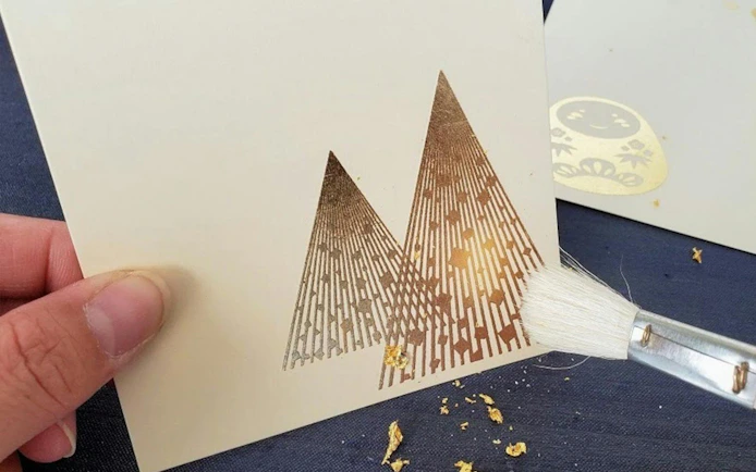 Gold leaf art creation on paper during Shirakawa-go Day Tour from Kanazawa.