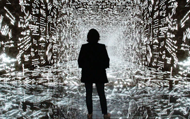 Visitor exploring digital art installation at Casa Batlló, Barcelona.