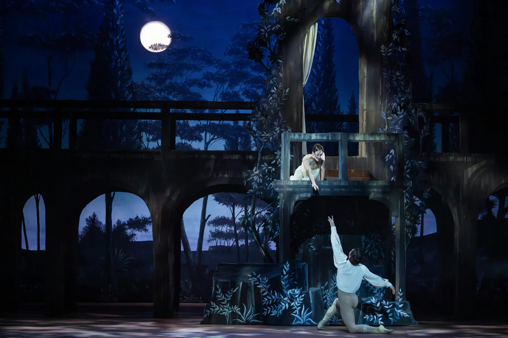 Australian Ballet's Romeo and Juliet balcony scene performance under moonlight.