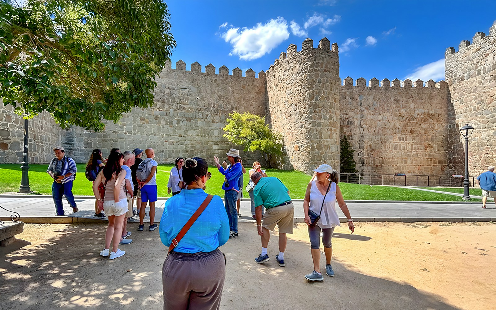 Tourists admiring the medieval city walls of Ávila, Spain.