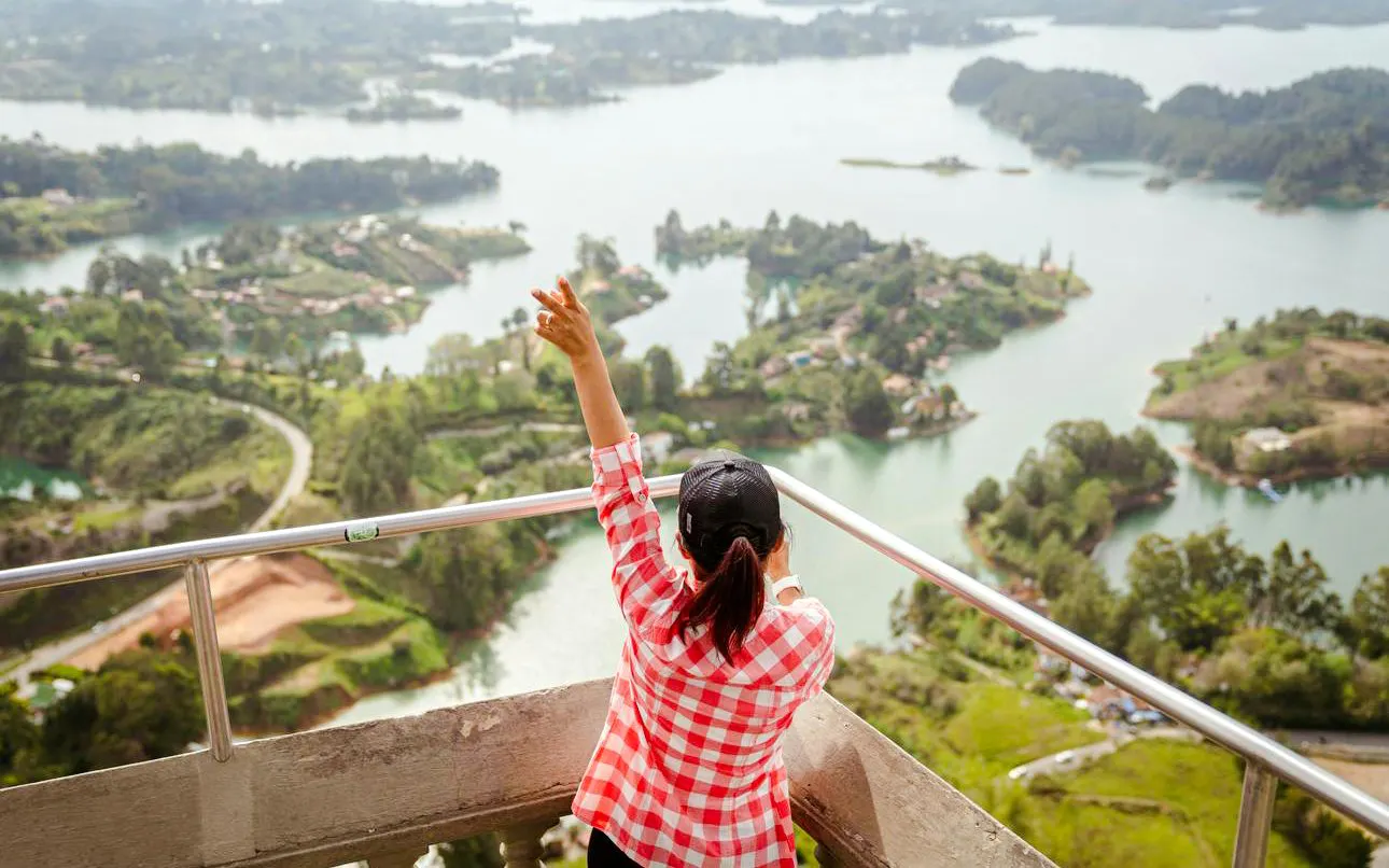 View from El Peñol overlooking green islands and blue reservoir in Guatapé, Antioquia, Colombia.