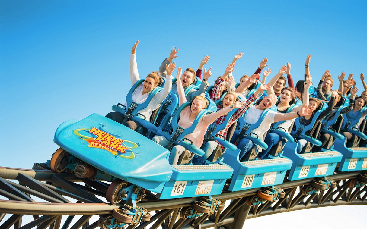 Roller coaster riders with raised hands at Heide Park.