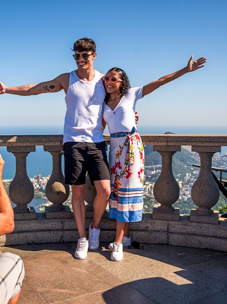 Guide photographing tourists at Christ the Redeemer, Rio de Janeiro.