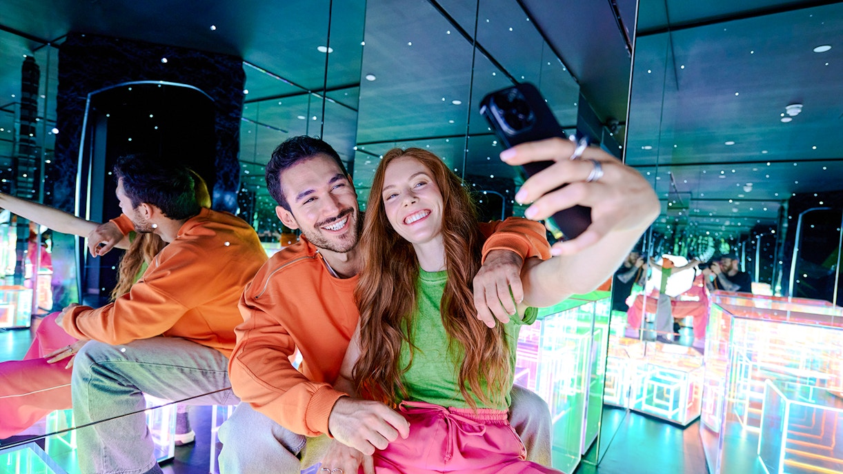 Guests taking a selfie in the mirrored room at Paradox Museum London.