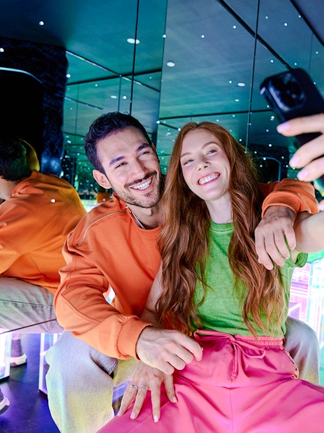 Guests taking a selfie in the mirrored room at Paradox Museum London.