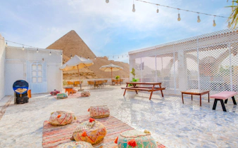 Dinner setup at Villa Khufu with view of the Great Pyramid in Giza, Egypt.