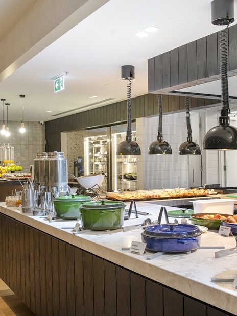 Buffet area at Holiday Inn & Suites Geelong with various food options and modern decor.