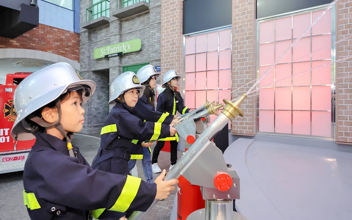 Children participating in a firefighter activity at KidZania Fukuoka.