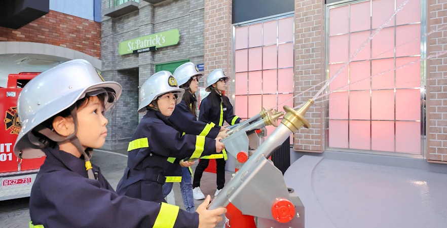 Children participating in a firefighter activity at KidZania Fukuoka.