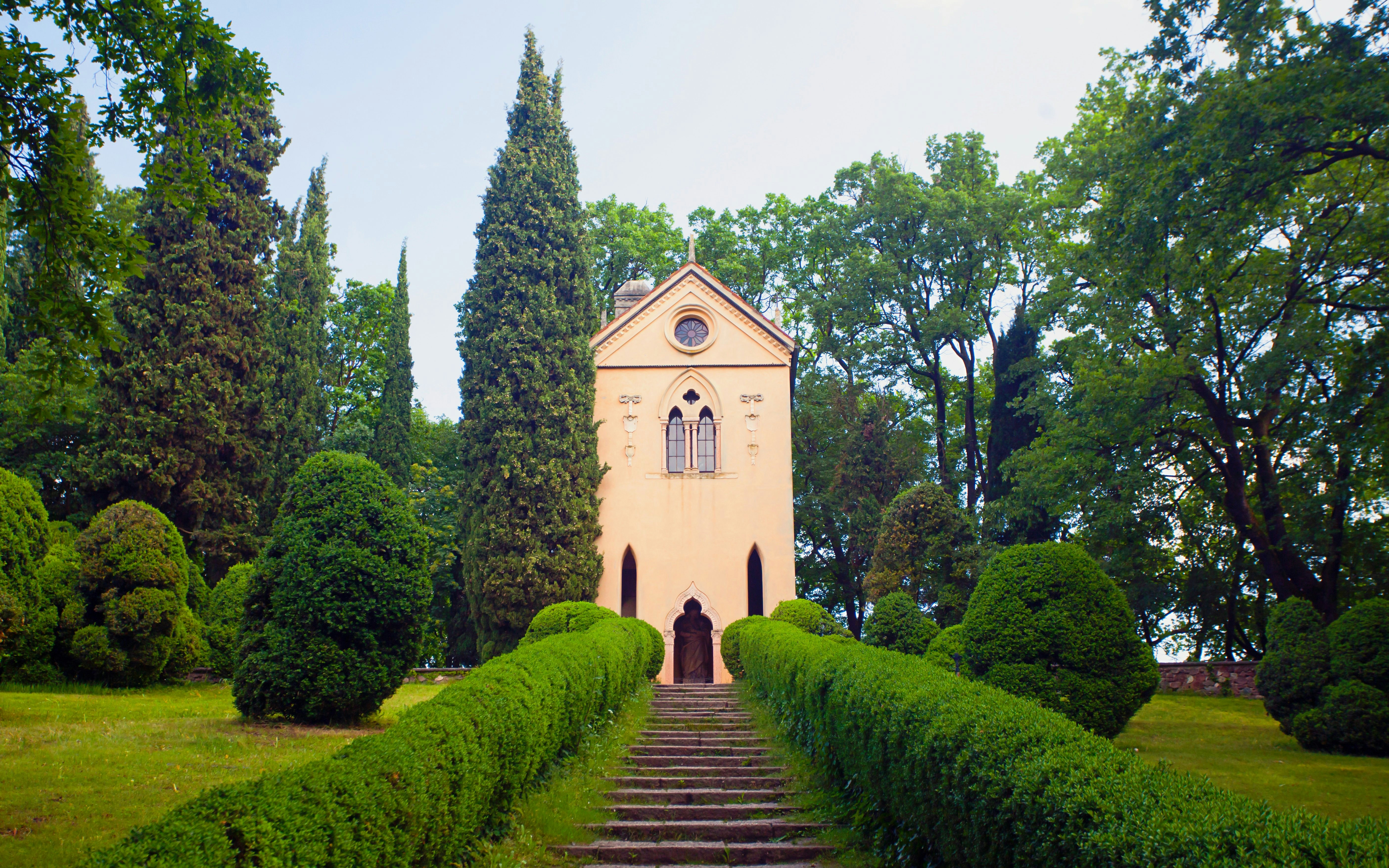 Sigurta Park's dog cemetery with chapel and manicured hedges in Italy.