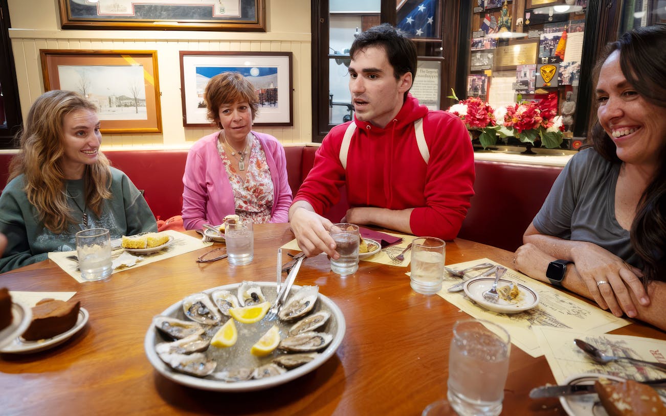 Dining experience with oysters at a restaurant in the Boston Seaport District during a walking tour.