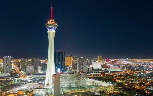 Stratosphere Tower illuminated at night in Las Vegas skyline.