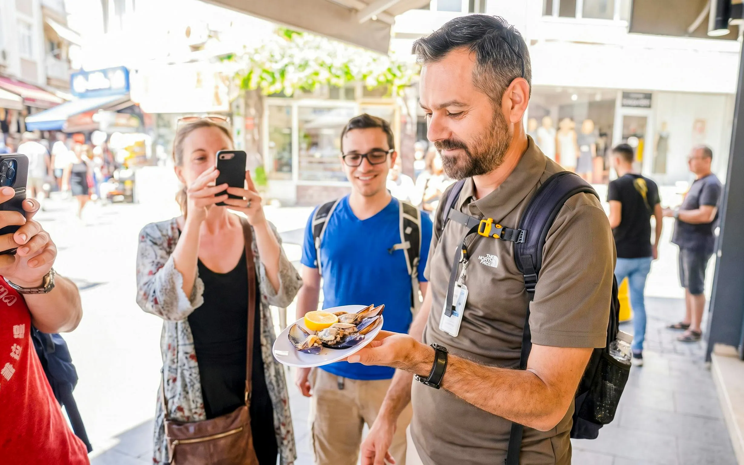 Man holding a plate of mussels with lemon during Istanbul food tour.