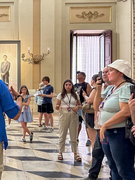 Tour group inside the Royal Palace of Madrid during a guided visit.