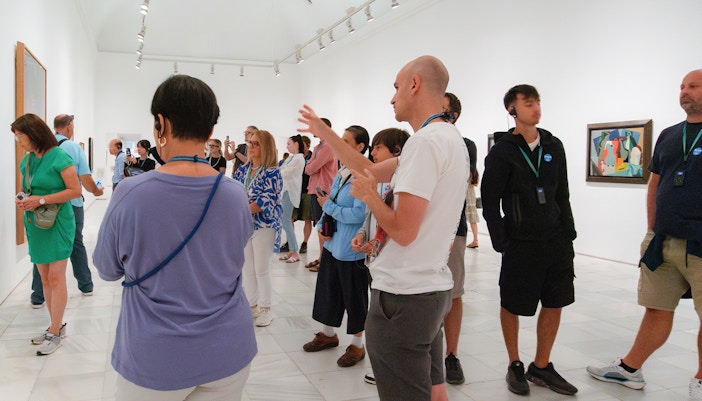Visitors exploring art exhibits at Prado & Reina Sofia Museum, Madrid, with skip-the-line entry.
