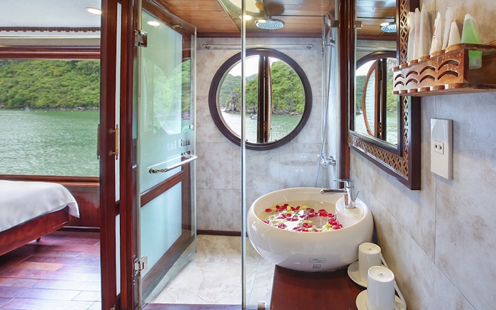 Cruise bathroom with round window view of Halong Bay, Vietnam.