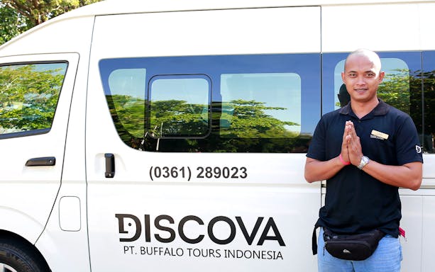 Shared airport transfer van with driver in Bali, Indonesia.