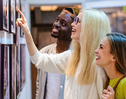 Visitors admiring artwork at a modern art exhibit.