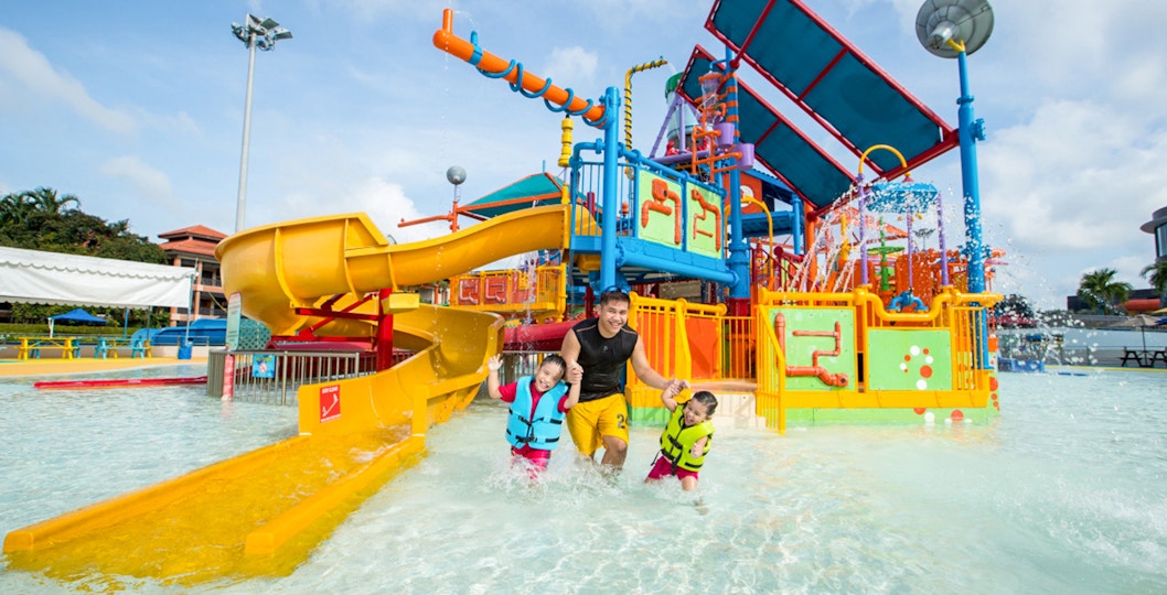 Family playing in water at Wild Wild Wet, Singapore.