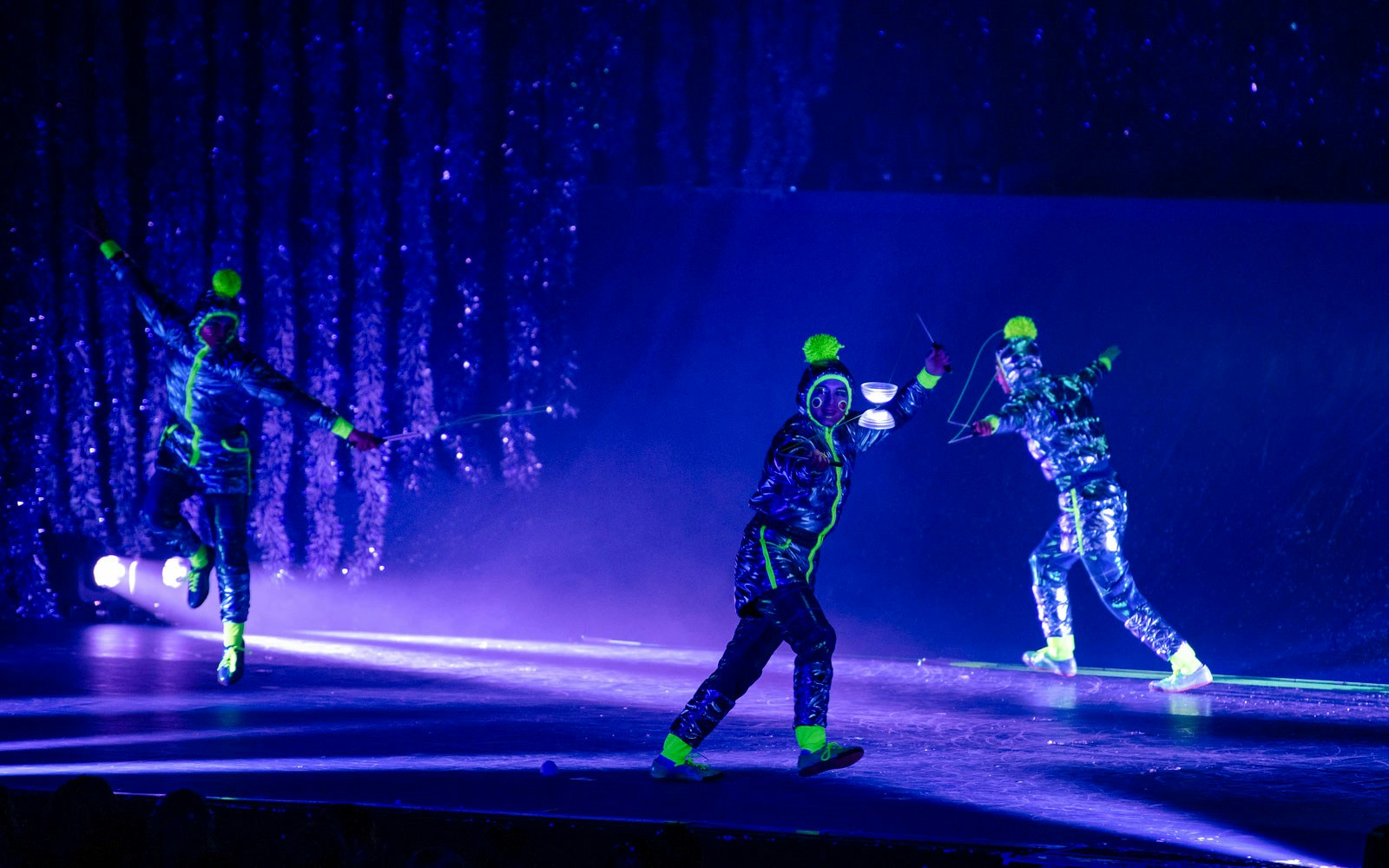 Performers in neon costumes during Cirque du Soleil's 'Twas The Night Before stage show.