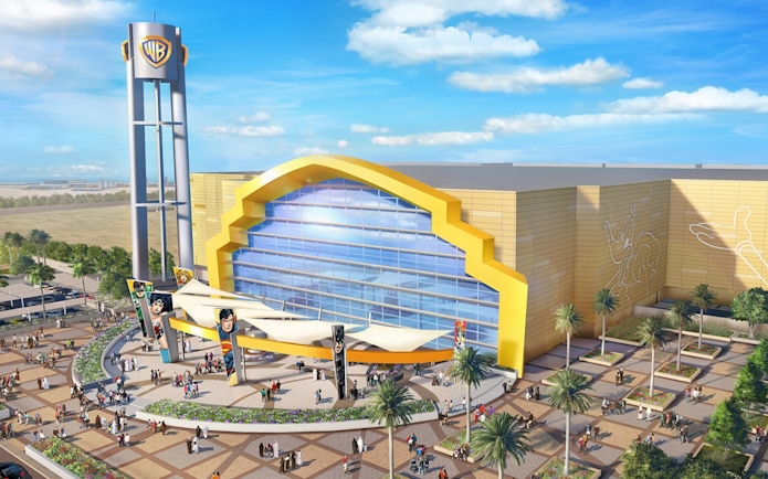 Warner Bros. World entrance on Yas Island, Abu Dhabi with visitors exploring the plaza.