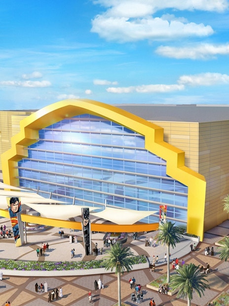 Warner Bros. World entrance on Yas Island, Abu Dhabi with visitors exploring the plaza.