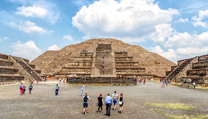 Visitors exploring the Pyramid of the Sun on a Teotihuacan Pyramids guided walking tour.