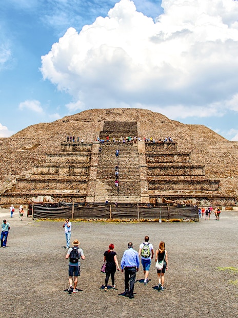 Visitors exploring the Pyramid of the Sun on a Teotihuacan Pyramids guided walking tour.