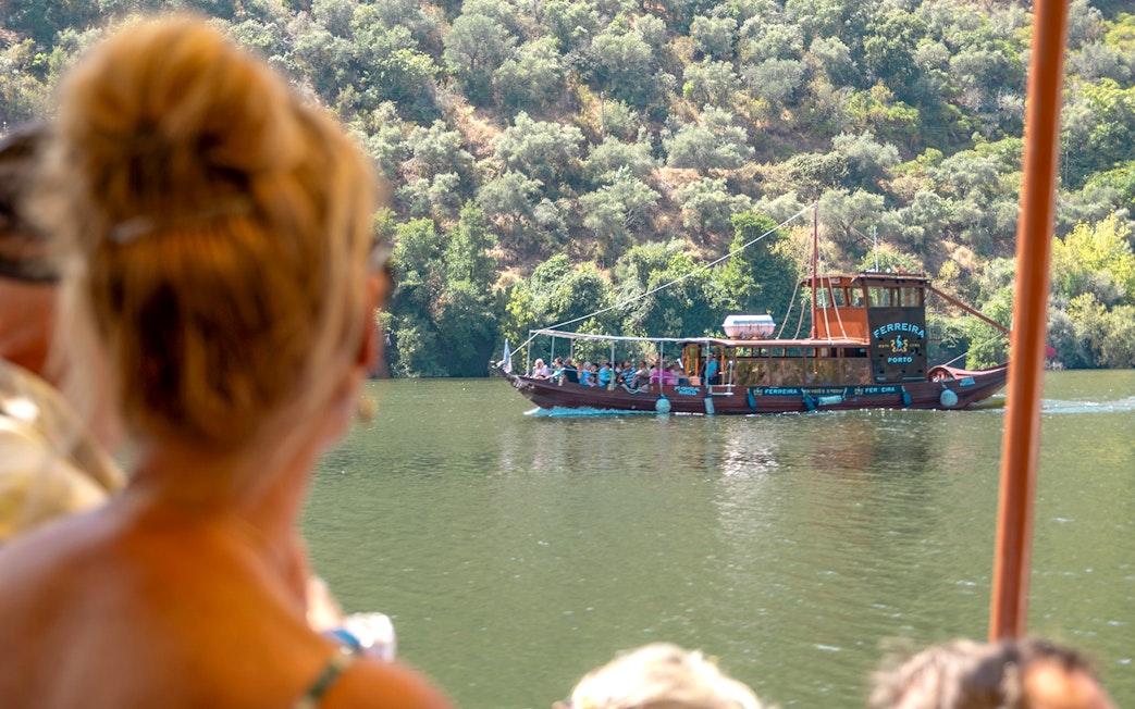 Boat cruising on the Douro River during a wine tour in Portugal.