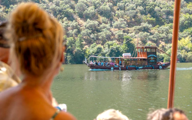 Boat cruising on the Douro River during a wine tour in Portugal.