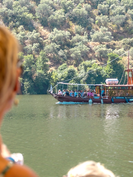 Boat cruising on the Douro River during a wine tour in Portugal.