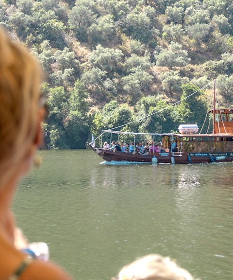 Boat cruising on the Douro River during a wine tour in Portugal.