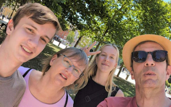 Group enjoying a sunny day in a Ljubljana park during a self-guided city exploration game.