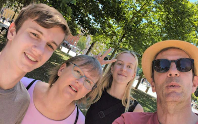 Group enjoying a sunny day in a Ljubljana park during a self-guided city exploration game.