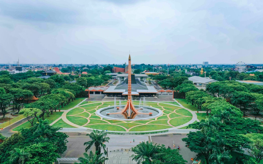 Aerial view of Taman Mini Indonesia, Jakarta, showcasing the central monument and surrounding greenery.